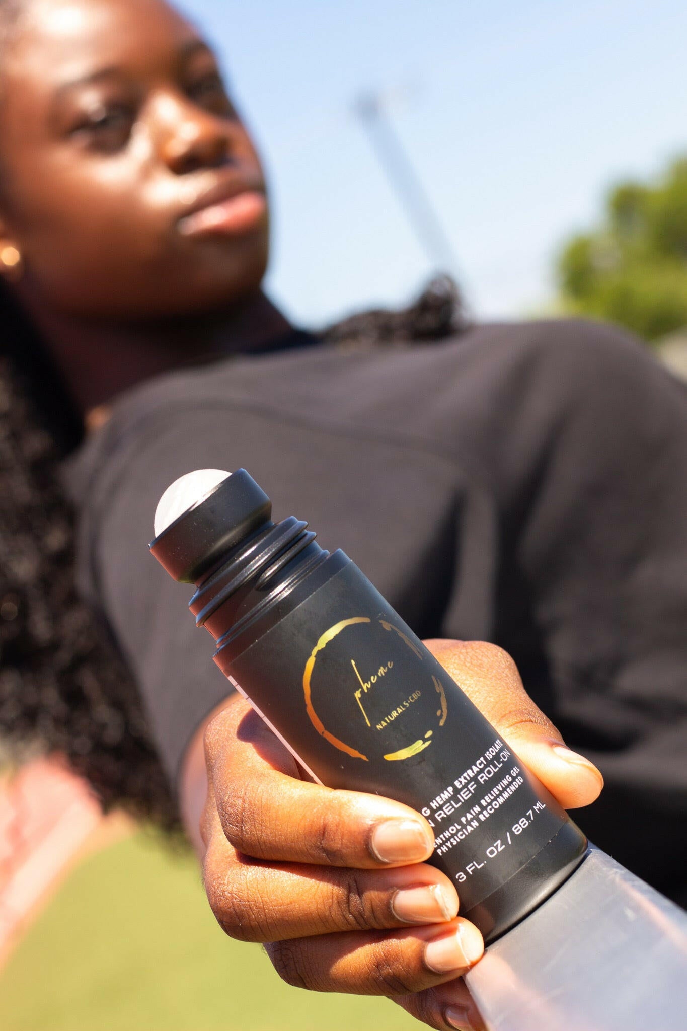 A Girl Holding Pheme Naturals Muscle gel